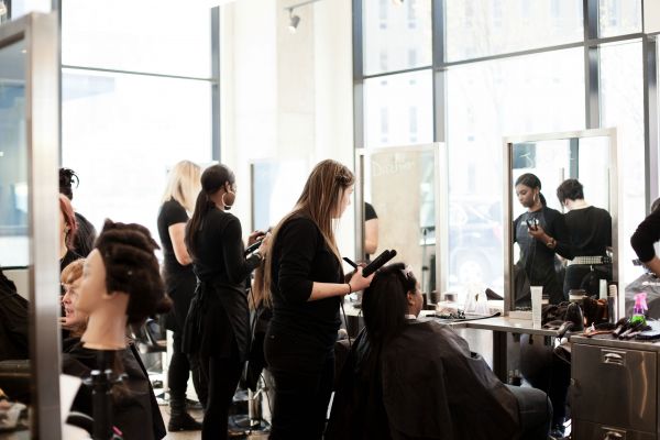 Group of Jean Madeline Aveda Institute students practicing in salon