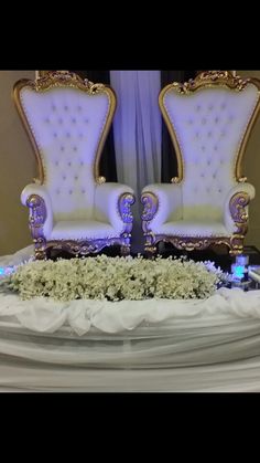 two white thrones at a wedding