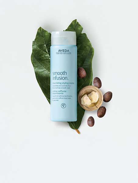 Aveda products on green leaf