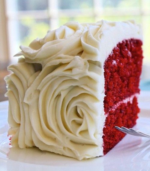 red velvet wedding cake slice with white floral frosting