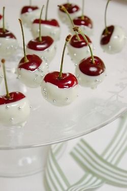 white chocolate dipped cherries displayed on a table