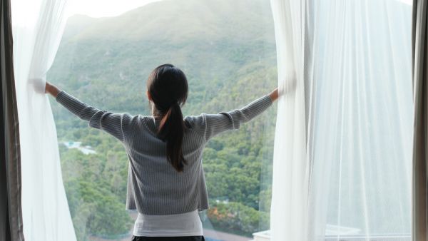 woman opens a window