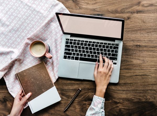 A beauty student gets ready to blog on a laptop.