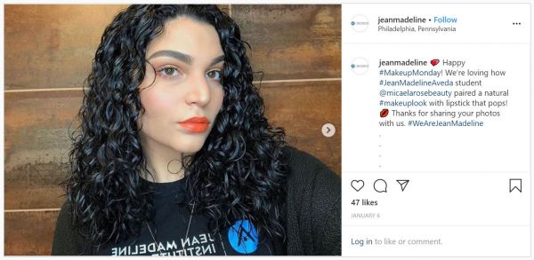 Jean Madeline Aveda Institute wearing shirt with logo and wearing makeup